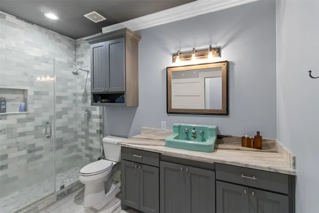 a bathroom with a toilet sink and mirror