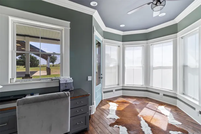 a living room with furniture and large windows