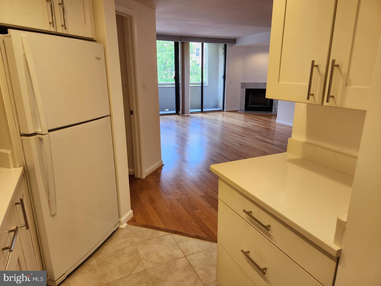 2725 Connecticut Avenue Northwest, Unit 406 Washington, DC 20008 - Photo 12 of 24 a view of a kitchen with refrigerator and wooden floor