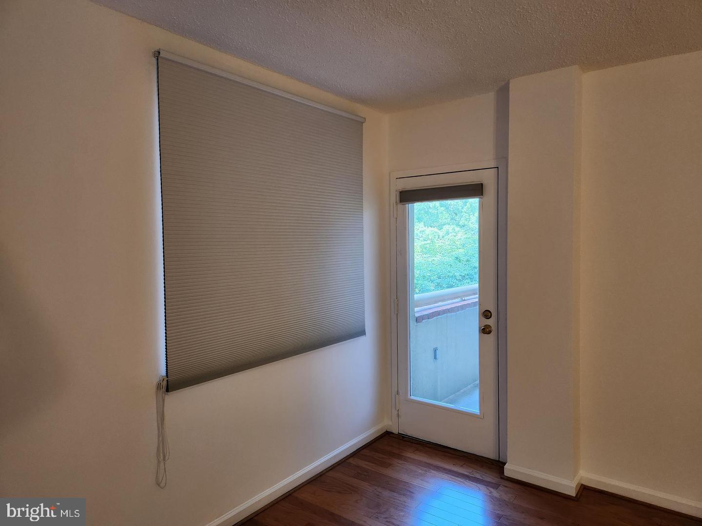 2725 Connecticut Avenue Northwest, Unit 406 Washington, DC 20008 - Photo 14 of 24 a view of an empty room with wooden floor