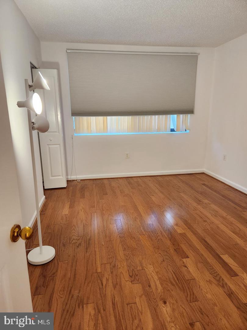 2725 Connecticut Avenue Northwest, Unit 406 Washington, DC 20008 - Photo 20 of 24 a view of an empty room and wooden floor