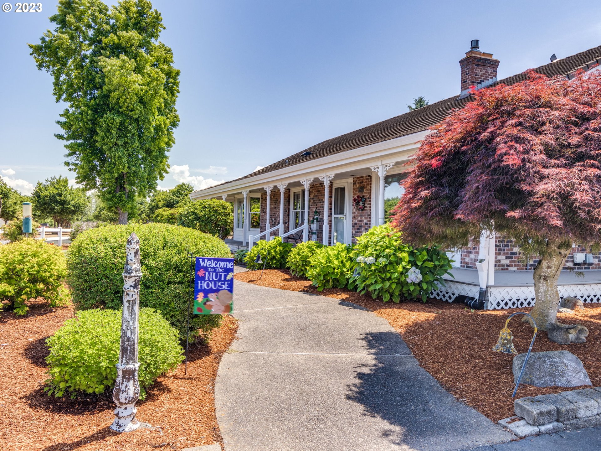 29600 South Dryland Road Canby, OR 97013 - Photo 7 of 48 a front view of a house with a yard and potted plants
