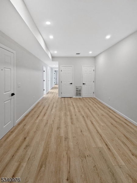 445 Grove Street, Unit 2 Irvington, NJ 07111 - Photo 2 of 11 a big room with wooden floor and natural light