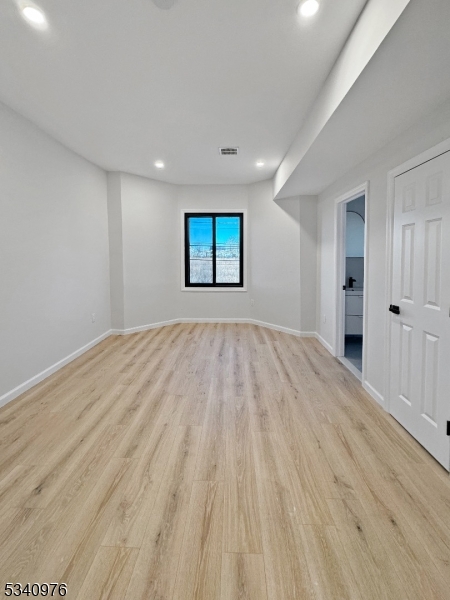445 Grove Street, Unit 2 Irvington, NJ 07111 - Photo 3 of 11 a view of empty room with wooden floor