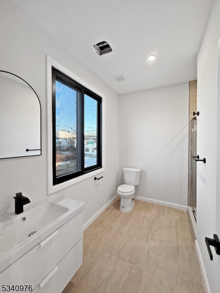 445 Grove Street, Unit 2 Irvington, NJ 07111 - Photo 5 of 11 a bathroom with a bathtub sink and a toilet