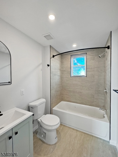 445 Grove Street, Unit 2 Irvington, NJ 07111 - Photo 8 of 11 a bathroom with a toilet and a bath tub