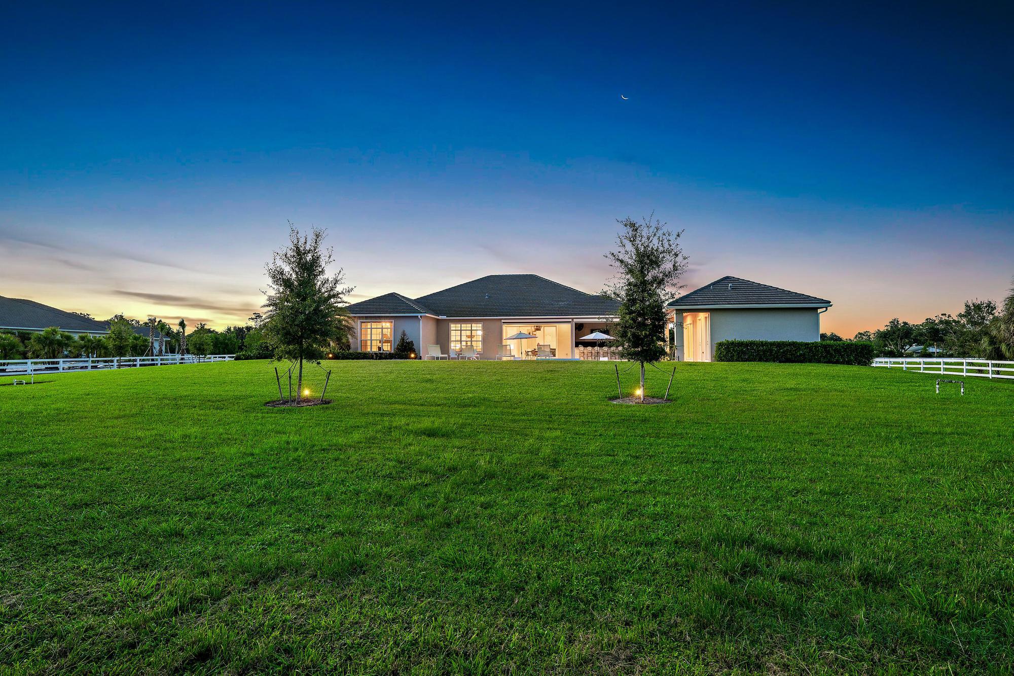 10096 Calabrese Trail Jupiter, FL 33478 - Photo 14 of 58 a front view of a house with garden
