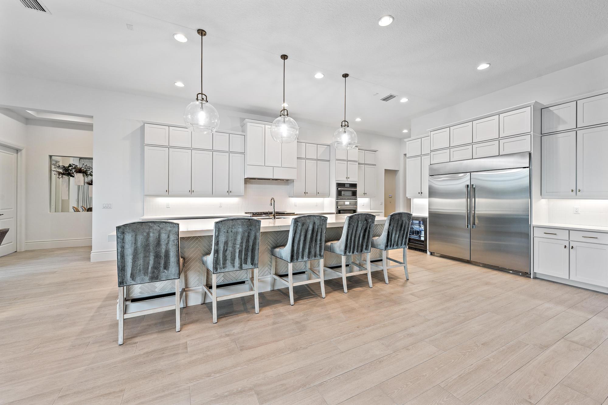 10096 Calabrese Trail Jupiter, FL 33478 - Photo 22 of 58 a large kitchen with a table and chairs