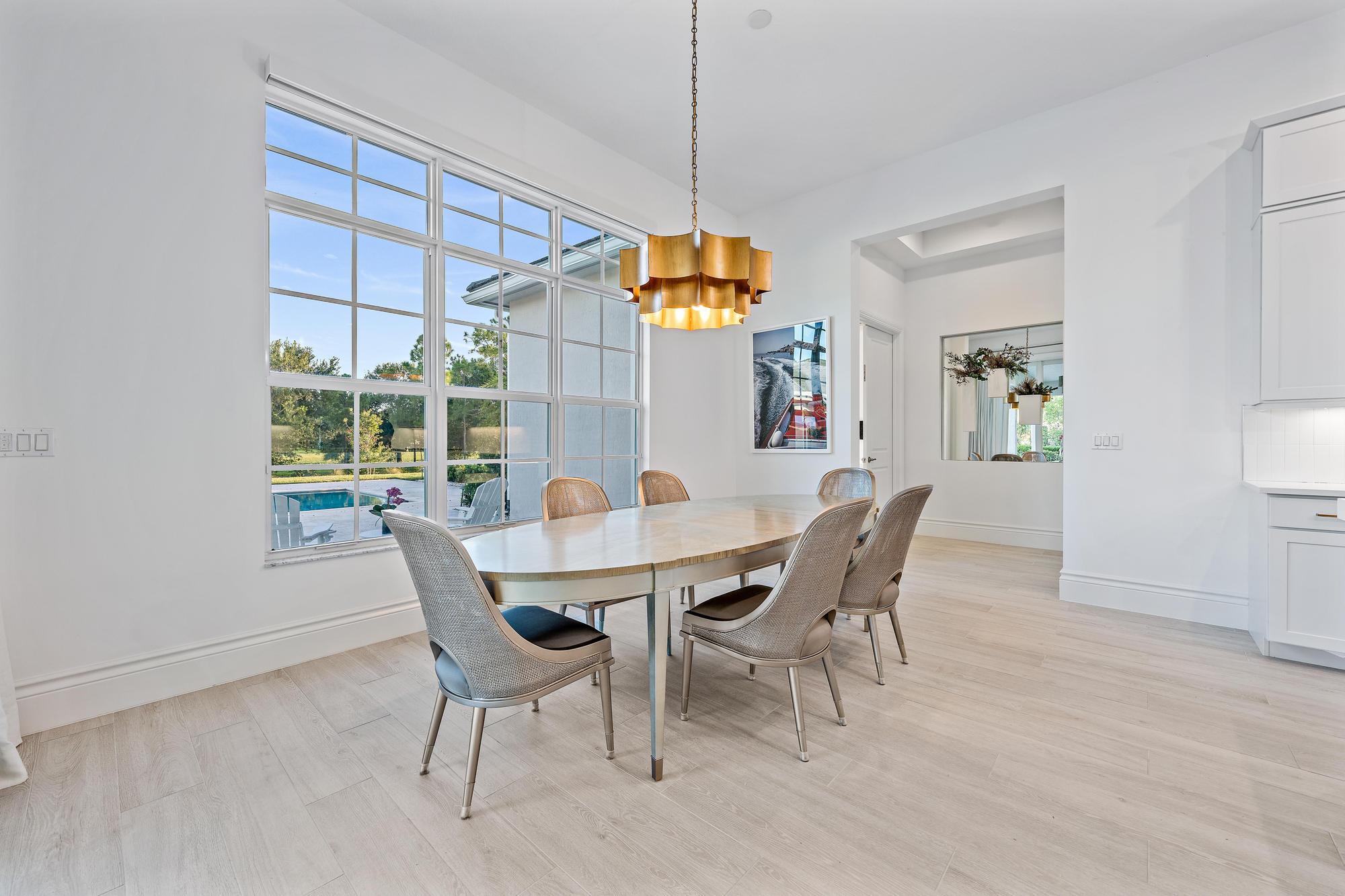 10096 Calabrese Trail Jupiter, FL 33478 - Photo 28 of 58 a dining room with furniture and window