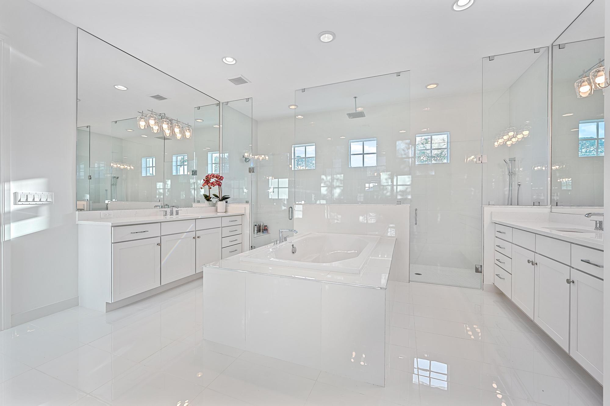 10096 Calabrese Trail Jupiter, FL 33478 - Photo 35 of 58 a large white kitchen with a lot of counter space and a sink