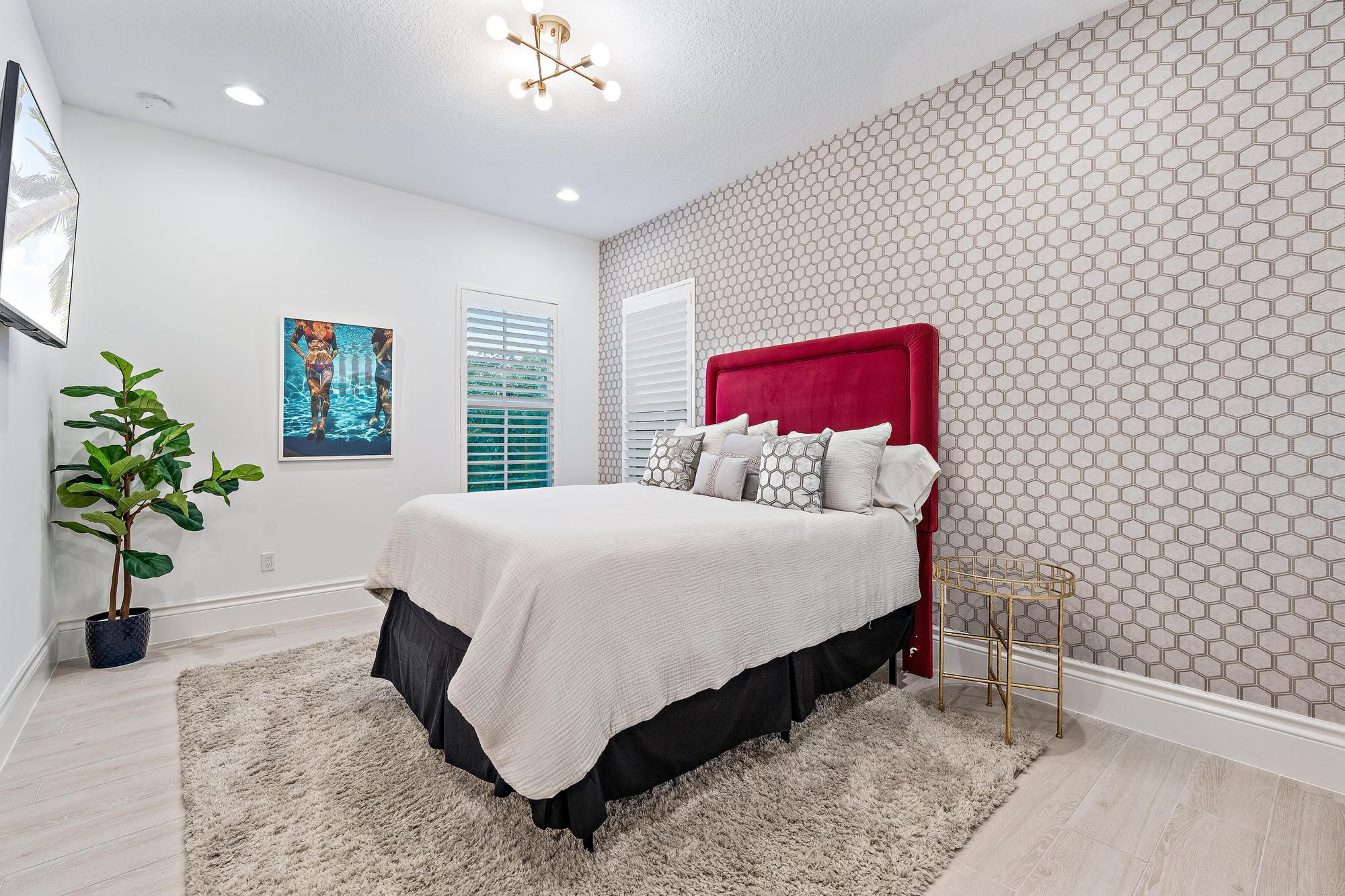 10096 Calabrese Trail Jupiter, FL 33478 - Photo 41 of 58 a bed sitting in a spacious bedroom next to a window and a potted plant