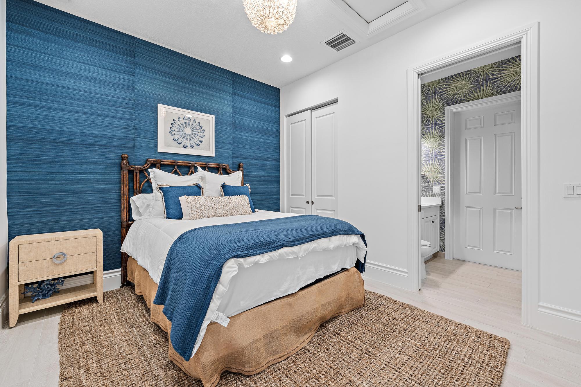 10096 Calabrese Trail Jupiter, FL 33478 - Photo 50 of 58 a bedroom with a bed and a night stand