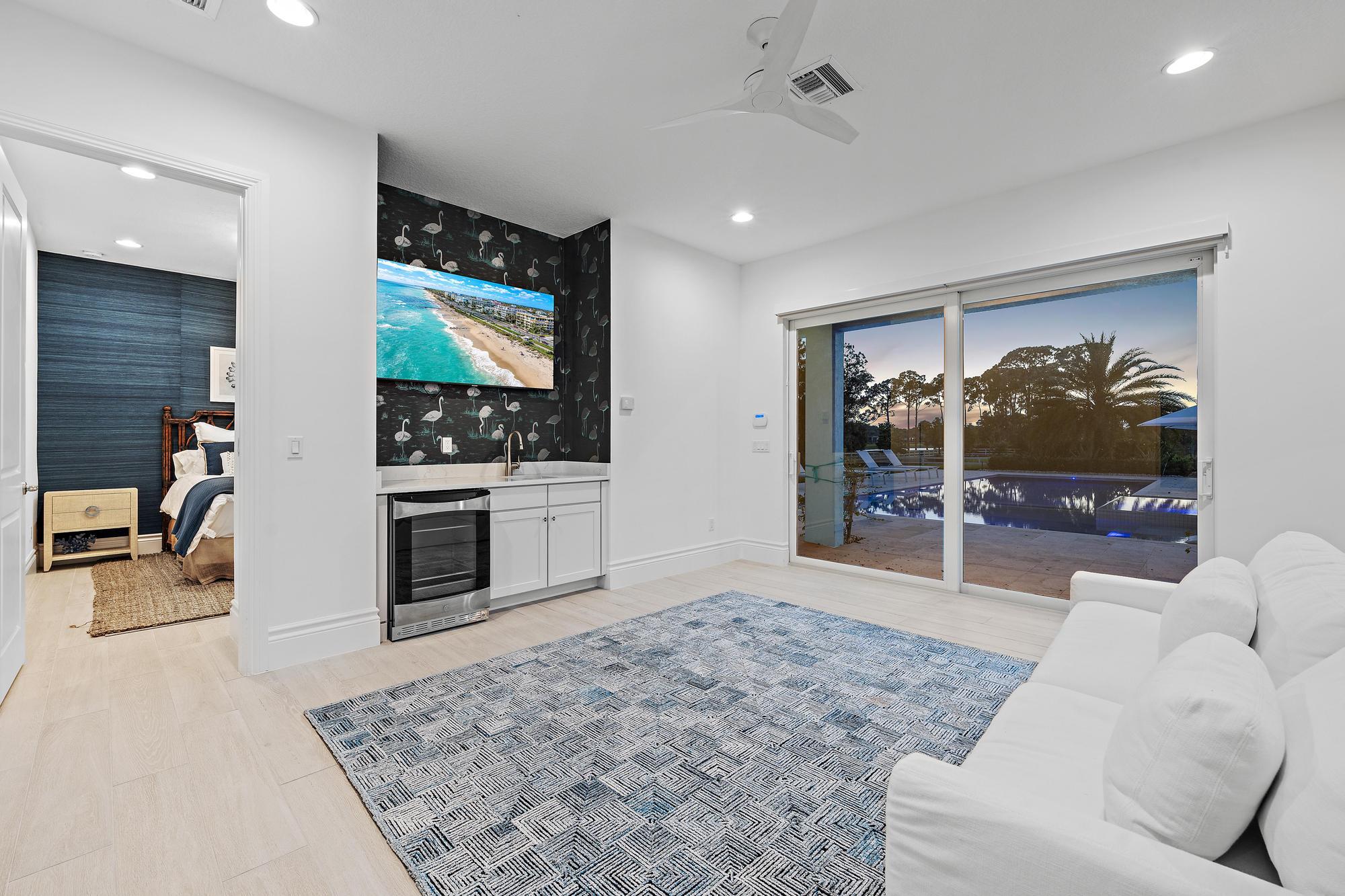 10096 Calabrese Trail Jupiter, FL 33478 - Photo 51 of 58 a living room with furniture and a flat screen tv