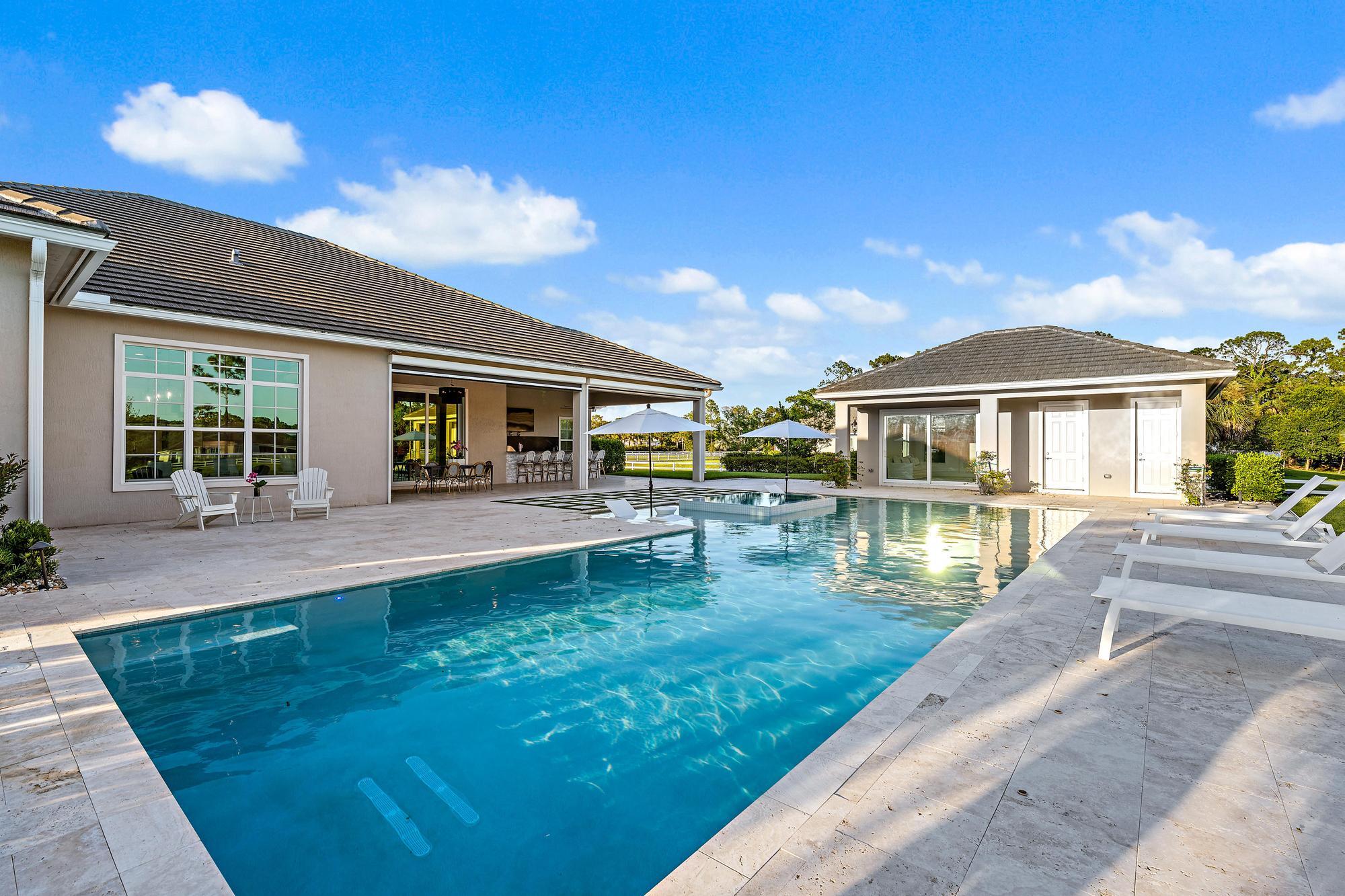 10096 Calabrese Trail Jupiter, FL 33478 - Photo 8 of 58 a view of house with swimming pool outdoor seating