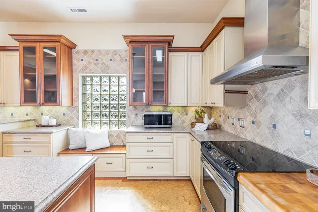 a large kitchen with kitchen island a sink table and chairs