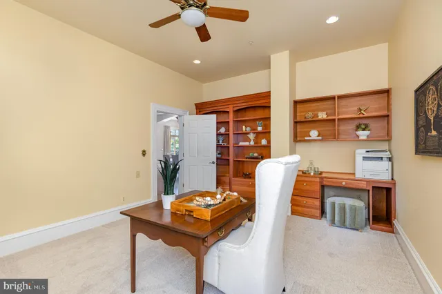 a view of a hallway with wooden floor and a bathroom