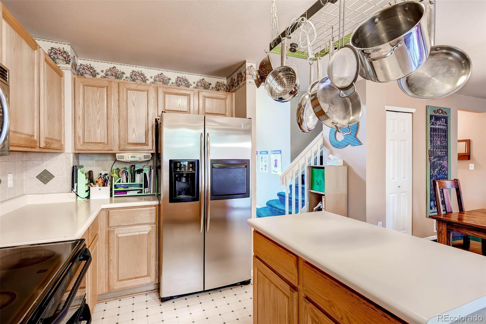 9645 South Castle Ridge Circle Highlands Ranch, CO 80129 - Photo 14 of 28 a kitchen with stainless steel appliances granite countertop a sink a oven and a refrigerator