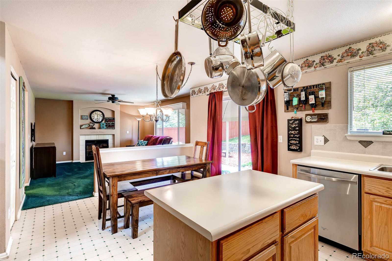 9645 South Castle Ridge Circle Highlands Ranch, CO 80129 - Photo 15 of 28 a kitchen with a table chairs and a stove
