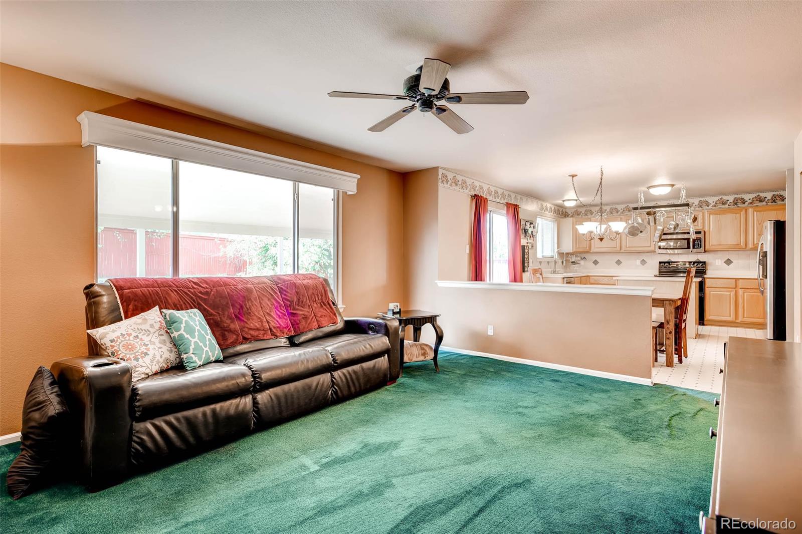 9645 South Castle Ridge Circle Highlands Ranch, CO 80129 - Photo 16 of 28 a living room with furniture and a large window