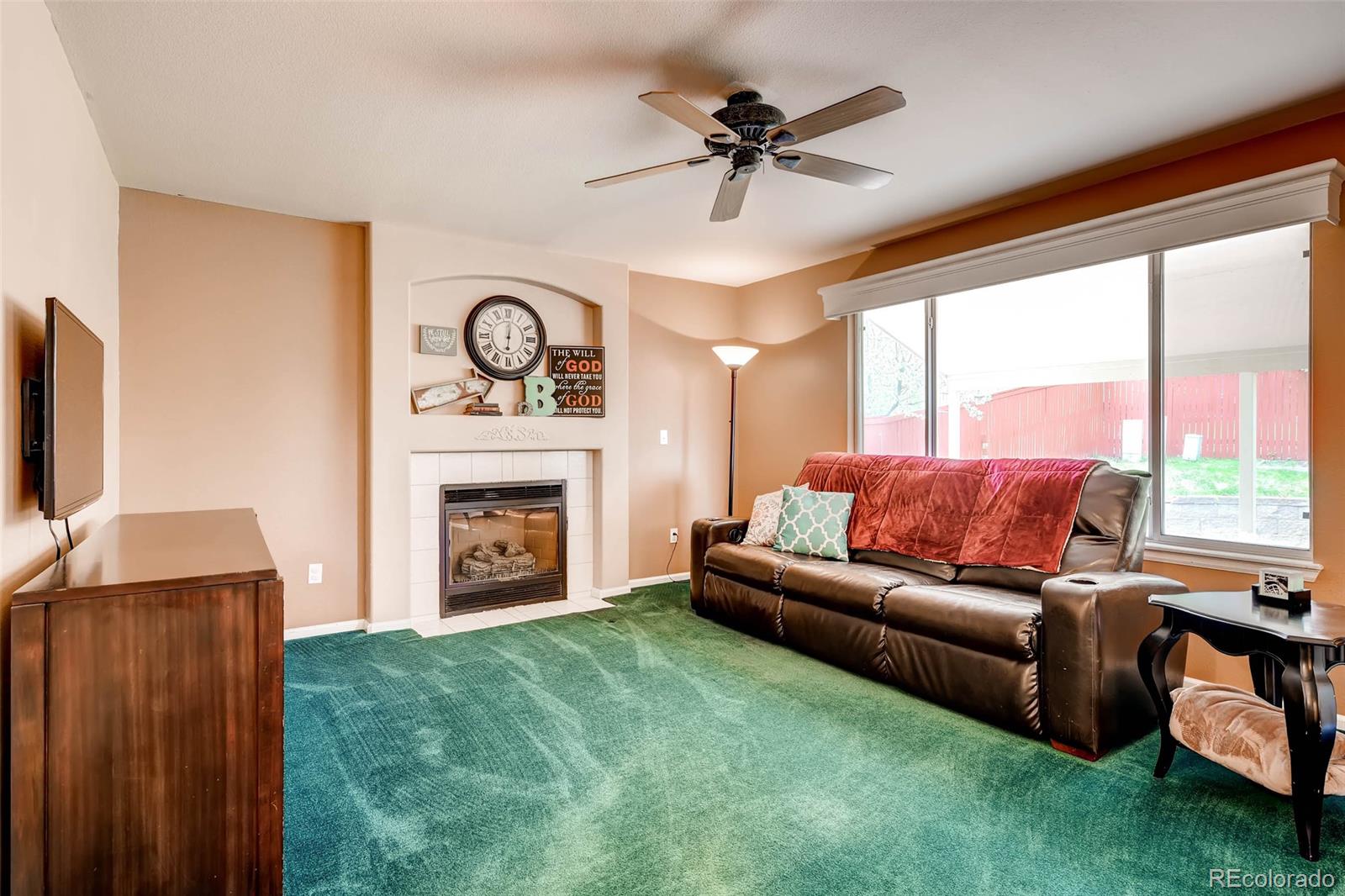 9645 South Castle Ridge Circle Highlands Ranch, CO 80129 - Photo 17 of 28 a living room with furniture a fireplace and a large window