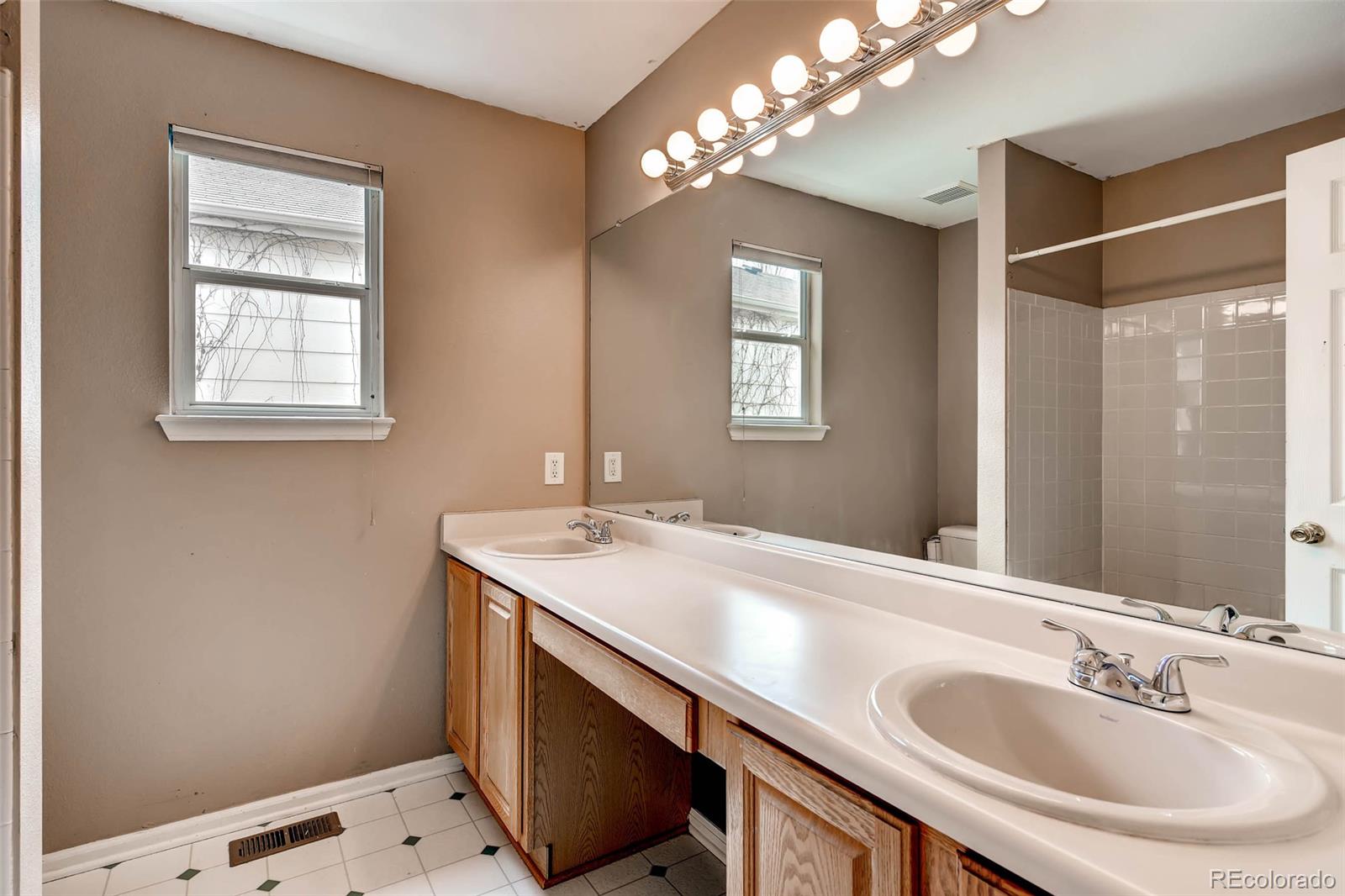 9645 South Castle Ridge Circle Highlands Ranch, CO 80129 - Photo 18 of 28 a bathroom with a sink and a mirror