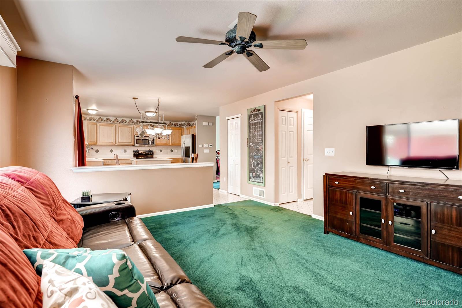 9645 South Castle Ridge Circle Highlands Ranch, CO 80129 - Photo 19 of 28 a living room with furniture and a flat screen tv