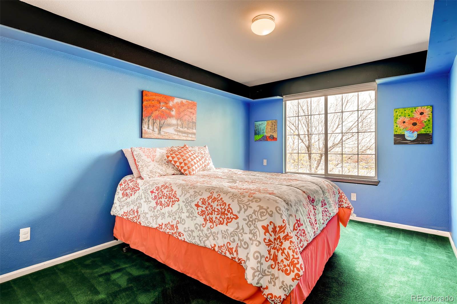 9645 South Castle Ridge Circle Highlands Ranch, CO 80129 - Photo 24 of 28 a bed sitting in a bedroom next to a window