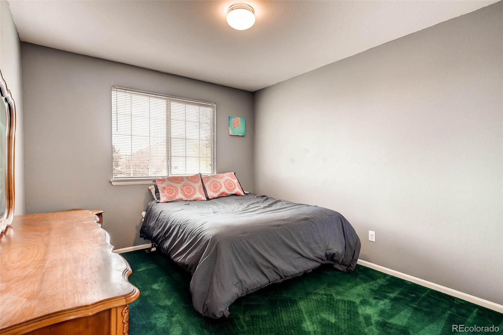 9645 South Castle Ridge Circle Highlands Ranch, CO 80129 - Photo 25 of 28 a bedroom with a bed and a window