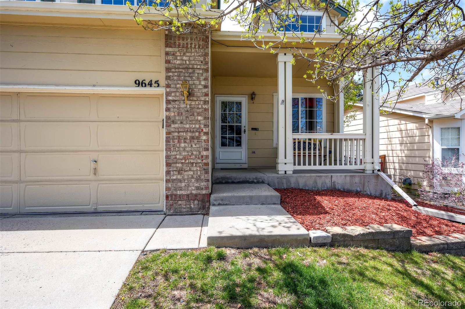 9645 South Castle Ridge Circle Highlands Ranch, CO 80129 - Photo 3 of 28 a view of a house with a small yard and wooden floor and fence
