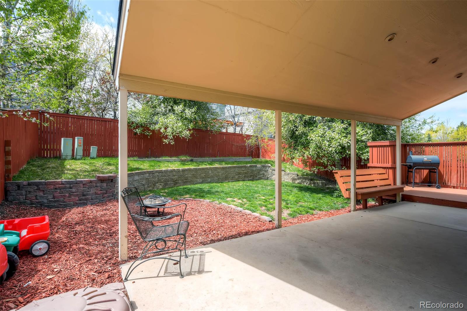 9645 South Castle Ridge Circle Highlands Ranch, CO 80129 - Photo 7 of 28 a view of a patio with a table chairs and a backyard