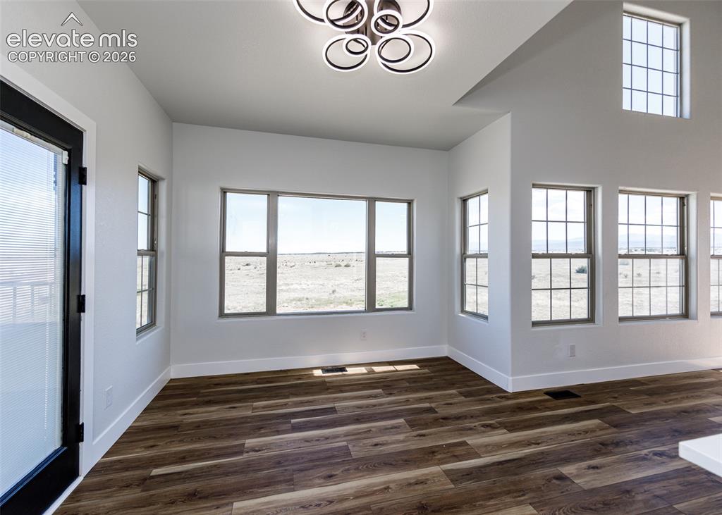 1120 Newton Road Pueblo, CO 81005 - Photo 10 of 46 a view of an empty room with a window and wooden floor