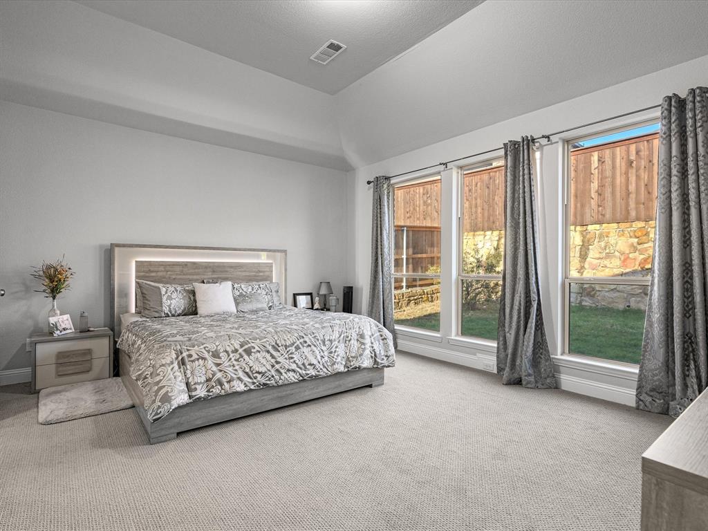 1606 Evening Primrose Drive Mansfield, TX 76063 - Photo 13 of 36 a bedroom with a large bed and a large window