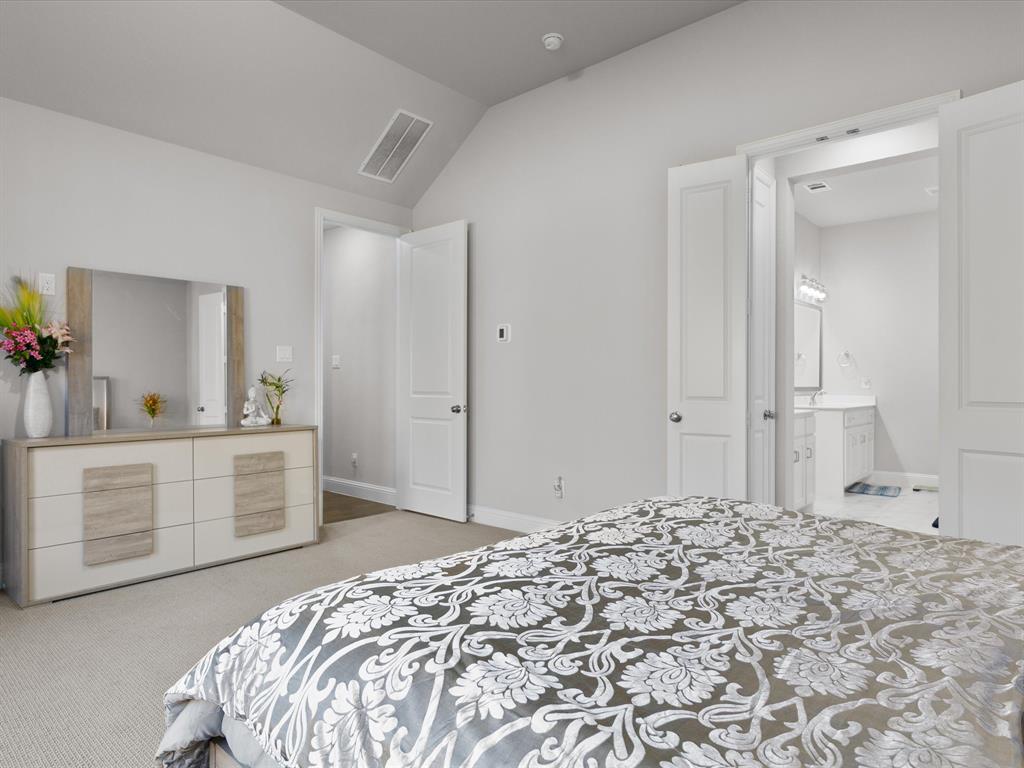 1606 Evening Primrose Drive Mansfield, TX 76063 - Photo 15 of 36 a spacious bedroom with a bed and cabinets