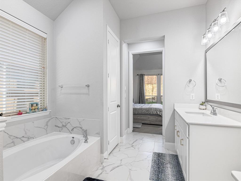 1606 Evening Primrose Drive Mansfield, TX 76063 - Photo 18 of 36 a spacious bathroom with a tub sink and mirror