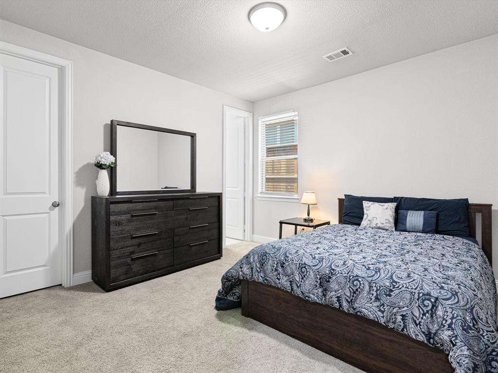1606 Evening Primrose Drive Mansfield, TX 76063 - Photo 20 of 36 a bedroom with a bed and a dresser