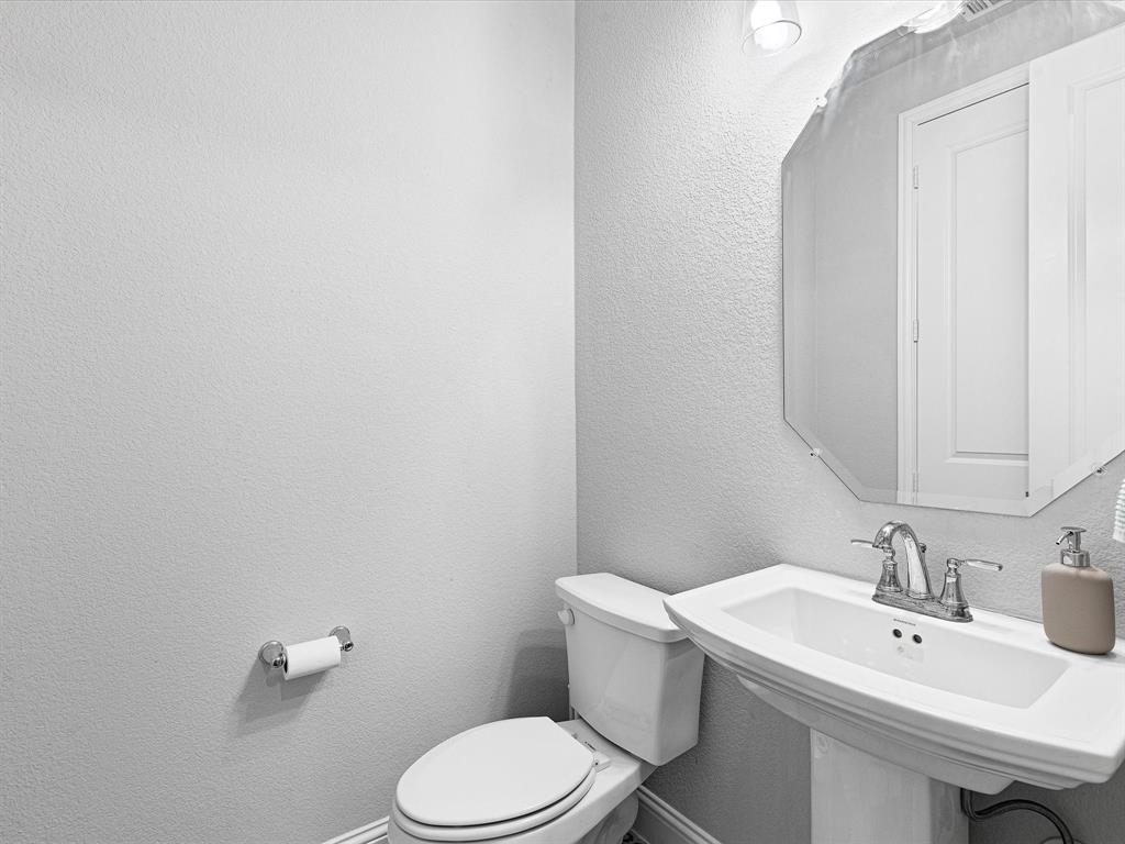 1606 Evening Primrose Drive Mansfield, TX 76063 - Photo 31 of 36 a bathroom with a sink mirror and toilet