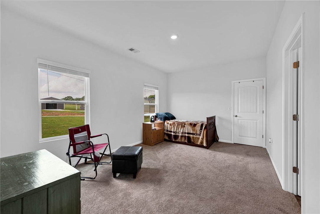 300 Clinkscales Road Anderson, SC 29624 - Photo 24 of 40 A well-lit bedroom provides comfortable living space with a soft carpet and dual windows.