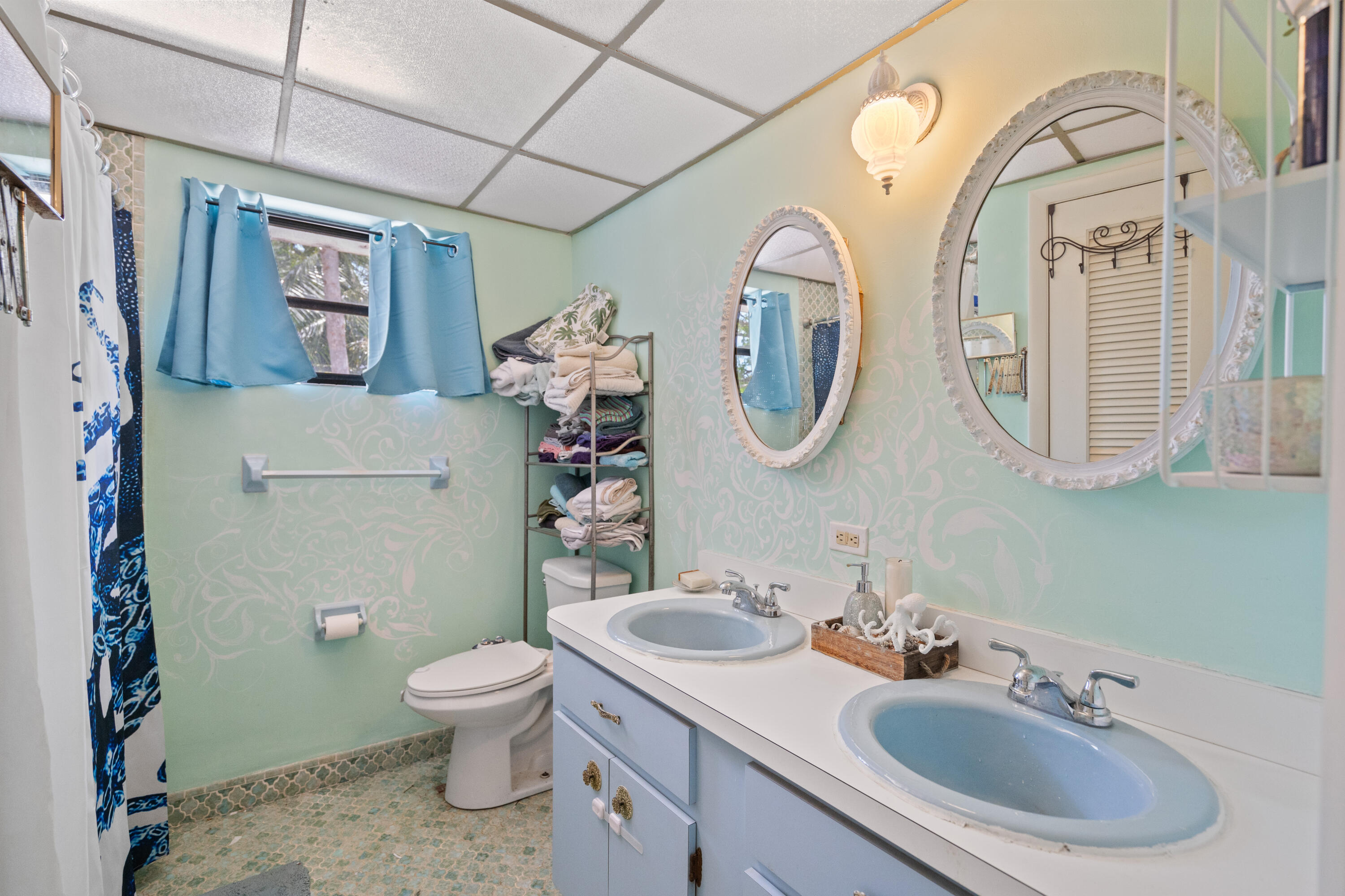 778 Canal Street Key Largo, FL 33037 - Photo 23 of 34 a bathroom with a toilet a sink and a mirror
