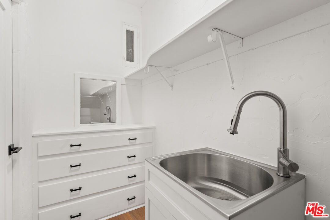 511 1/2 North Hobart Boulevard Los Angeles, CA 90004 - Photo 14 of 15 a kitchen with white cabinets and a sink