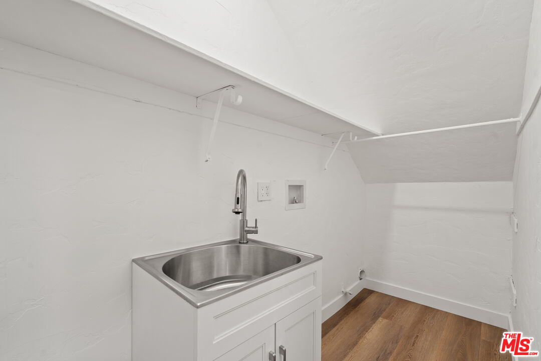 511 1/2 North Hobart Boulevard Los Angeles, CA 90004 - Photo 15 of 15 a kitchen with a sink and cabinets