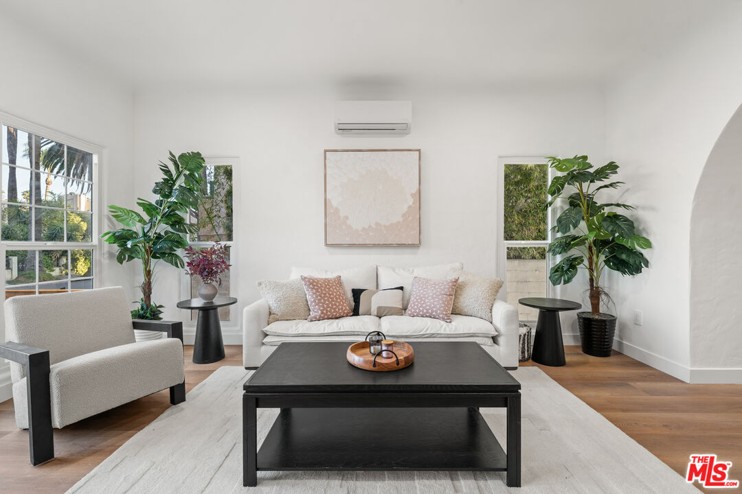 511 1/2 North Hobart Boulevard Los Angeles, CA 90004 - Photo 4 of 15 a living room with furniture and a potted plant