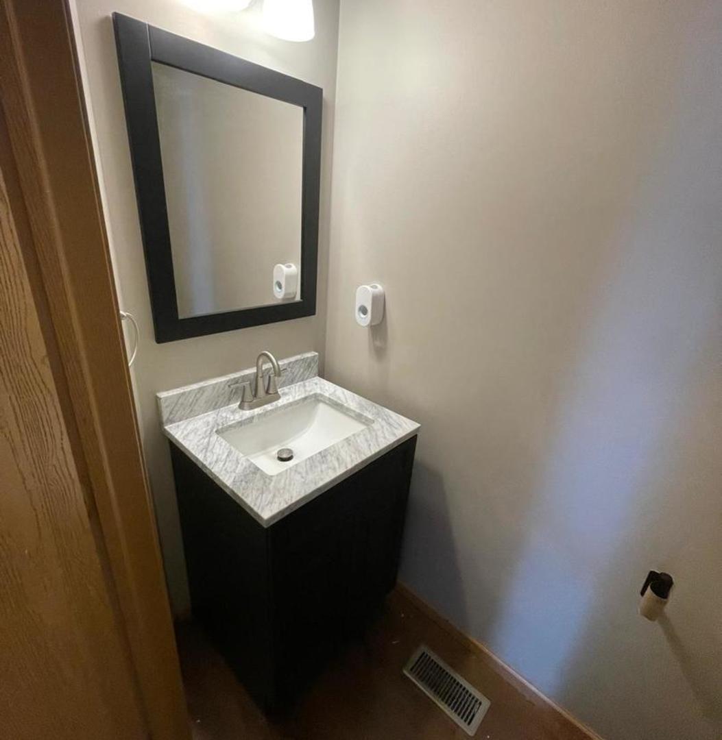 458 Landmark Avenue, Unit 458 Yorkville, IL 60560 - Photo 8 of 19 a bathroom with a sink and a mirror