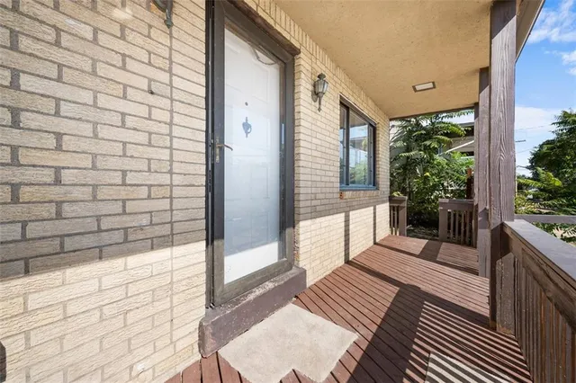 a view of a balcony with wooden floor