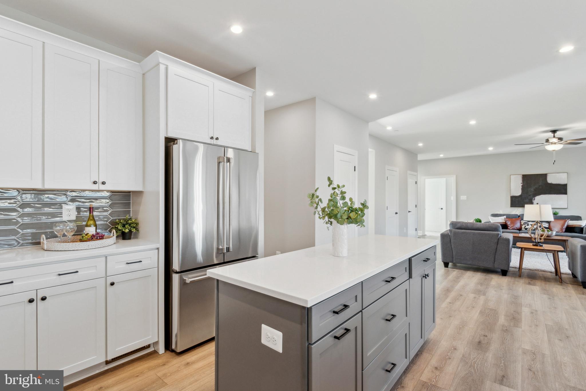 2204 Arden Drive Fallston, MD 21047 - Photo 6 of 32 a kitchen with stainless steel appliances kitchen island granite countertop a refrigerator and a stove top oven