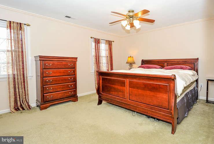 7801 Cliffside Court Springfield, VA 22153 - Photo 15 of 30 a bed room with a bed and a chandelier