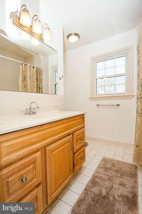 7801 Cliffside Court Springfield, VA 22153 - Photo 17 of 30 a bathroom with a sink a vanity and mirror
