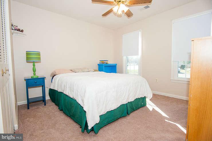 7801 Cliffside Court Springfield, VA 22153 - Photo 19 of 30 a bedroom with a bed and a chandelier