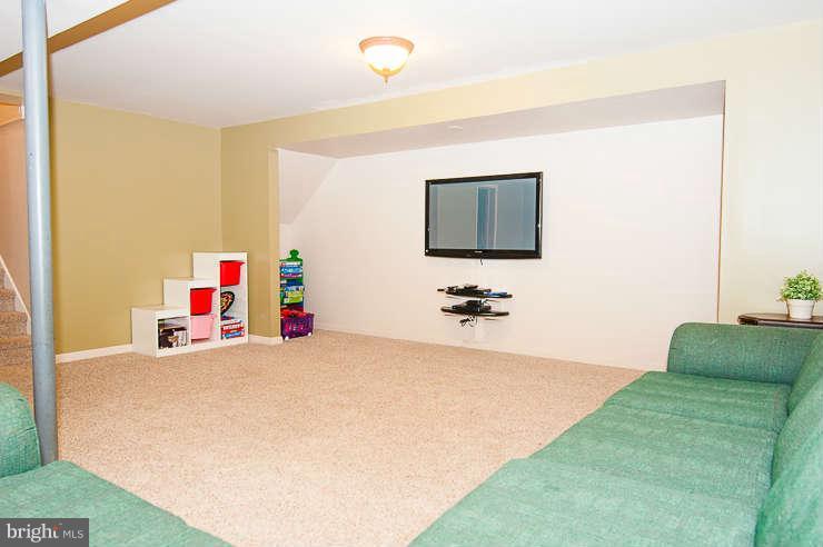 7801 Cliffside Court Springfield, VA 22153 - Photo 23 of 30 a bedroom with a bed and a flat screen tv