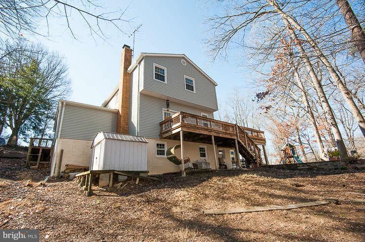 7801 Cliffside Court Springfield, VA 22153 - Photo 26 of 30 a view of a wooden house with a yard covered with snow