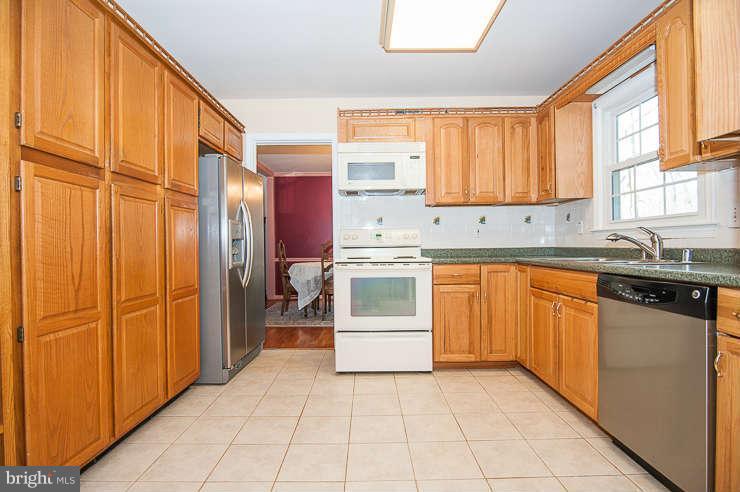 7801 Cliffside Court Springfield, VA 22153 - Photo 9 of 30 a kitchen with stainless steel appliances granite countertop a refrigerator and a sink